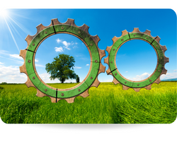 Two wooden gears with green tree in countryside, concept of green economy